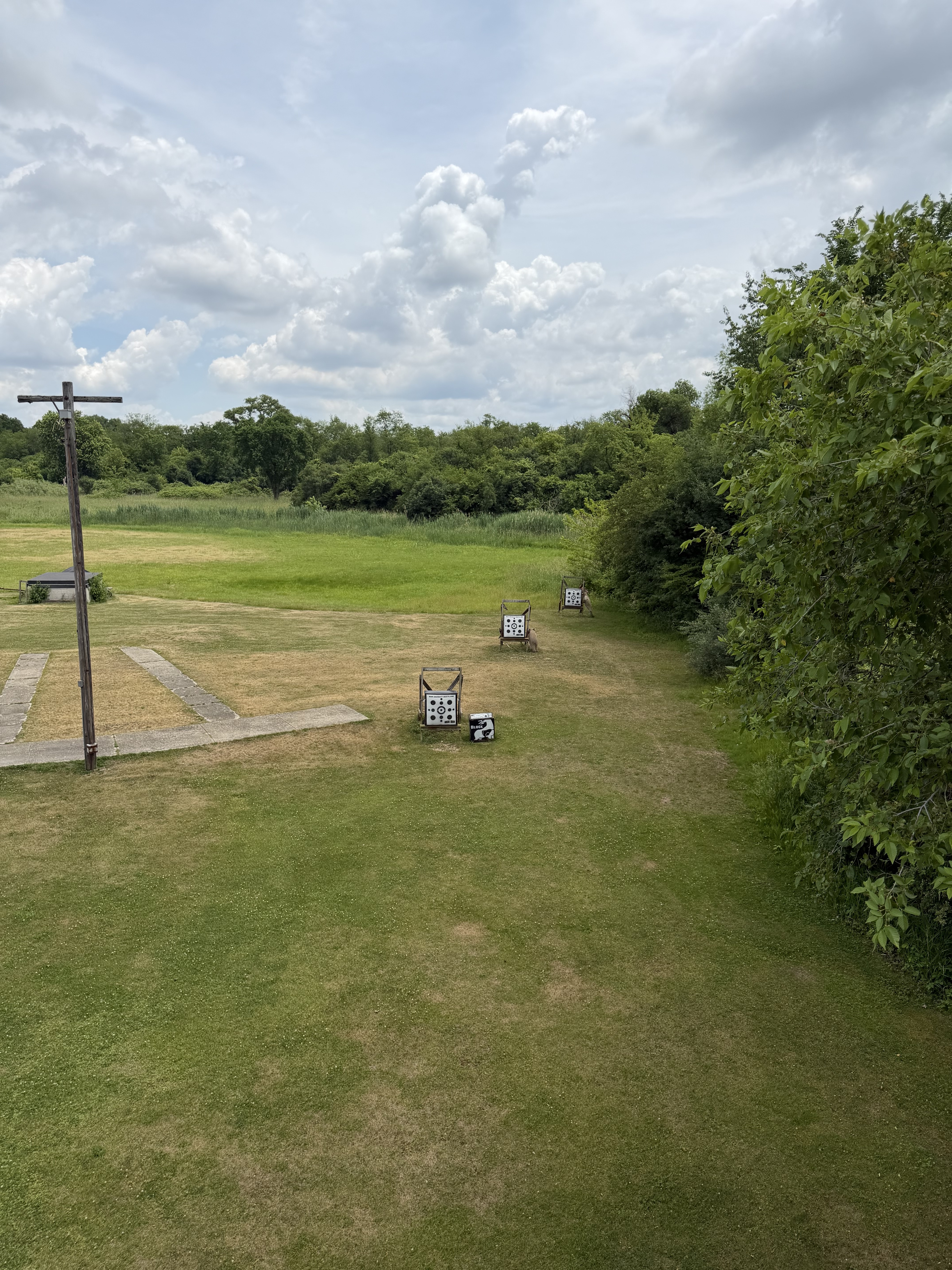 Deer Creek Recreation Club archery range with target stands set across a mowed shooting lane bordered by woodland in Plainfield Illinois