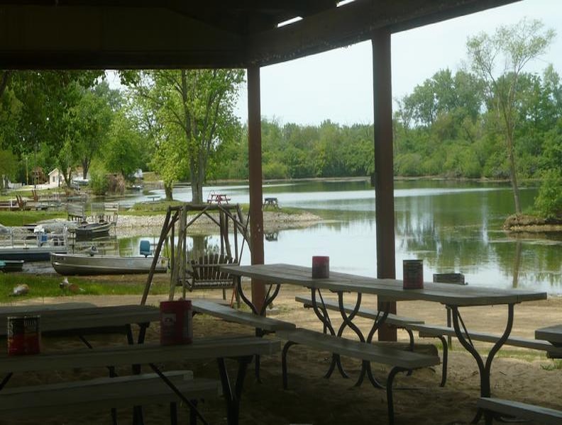 The Deer Creek Recreation Club pavilion with picnic tables and a view over the lake in Plainfield Illinois